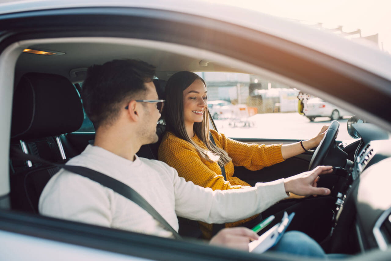 woman takes driving test with a male instructor